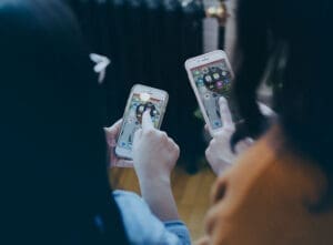 two girls with smartphones